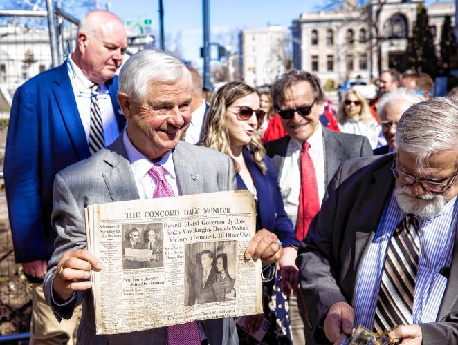 Sen. Jeb Bradley holds up a copy of the Concord Monitor that was in the time capsule at the former DOJ and Mechanics Bank building on North State Street on Tuesday.