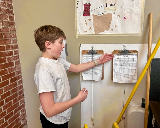 Owen Lanman, a sixth grader looks at the data of all the compost collected from Maple Street School’s cafeteria 