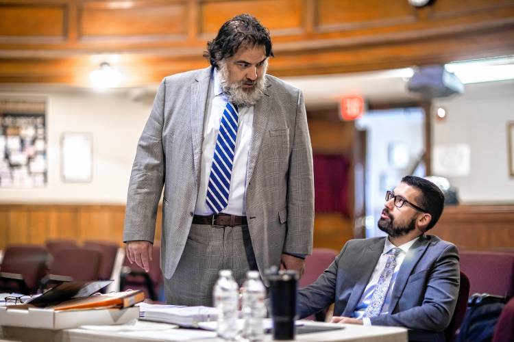 Lawyer Peter Perroni (left) confers with Jacob Drouin, a former Franklin police officer and union president during the city’s personnel advisory board hearing at the Franklin City Hall on Tuesday.