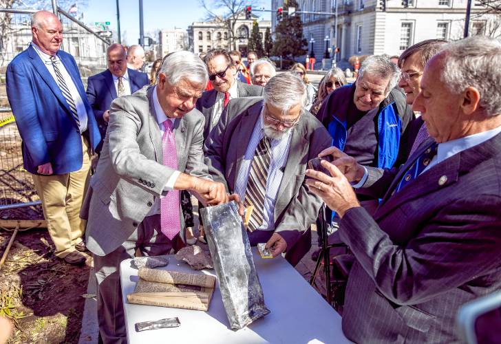 Senator Jeb Bradley and House Speaker inspect the time capsule as they open it at the old DOJ building on North State Street in Concord on Tuesday, April 0, 2024.