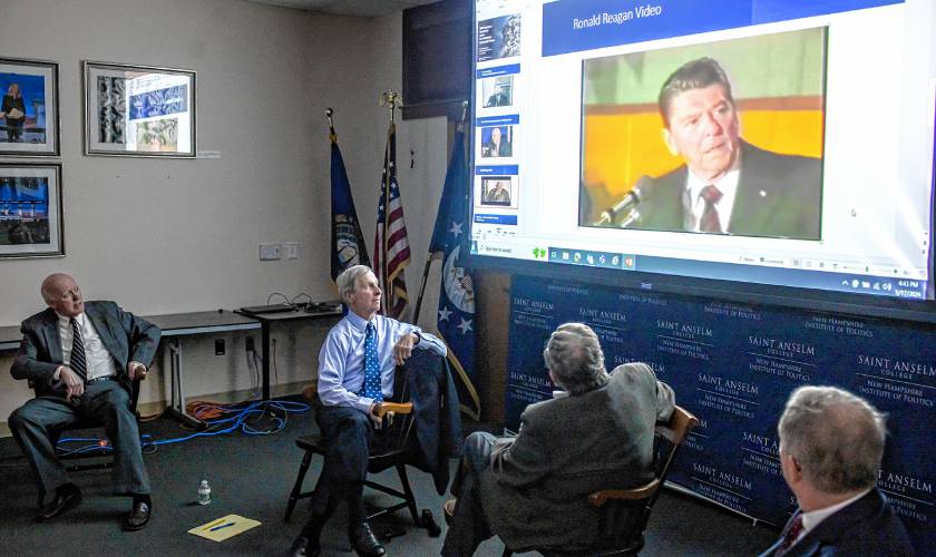 Former New Hampshire Secretary of State Bill Gardner (left), former Governor John Lynch, former Governor John Sununu, Sr. and current Secretary of State David Scanlan watch an old clip of candidate Ronald Reagan yelling that he paid for a microphone before a Nashua event before the 1980 election.  The St. Anselm’s Governor’s Roundtable on the New Hampshire Presidential Primary on Wednesday.