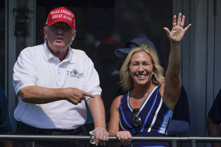 FILE - Rep. Marjorie Taylor Greene, R-Ga., waves while former President Donald Trump points to her while they look over the 16th tee during the second round of the Bedminster Invitational LIV Golf tournament, July 30, 2022, in Bedminster, N.J. While vice presidential candidates typically aren't tapped until after a candidate has locked down the nomination, Trump's decisive win in the Iowa caucuses and the departure of Florida Gov. Ron DeSantis from the race has only heightened what...