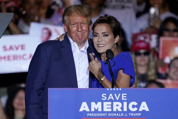 FILE - Arizona Republican gubernatorial candidate Kari Lake, right, speaks as former President Donald Trump listens during a rally, Oct. 9, 2022, in Mesa, Ariz. While vice presidential candidates typically aren't tapped until after a candidate has locked down the nomination, Trump's decisive win in the Iowa caucuses and the departure of Florida Gov. Ron DeSantis from the race has only heightened what had already been a widespread sense of inevitability. Lake is considered a close...