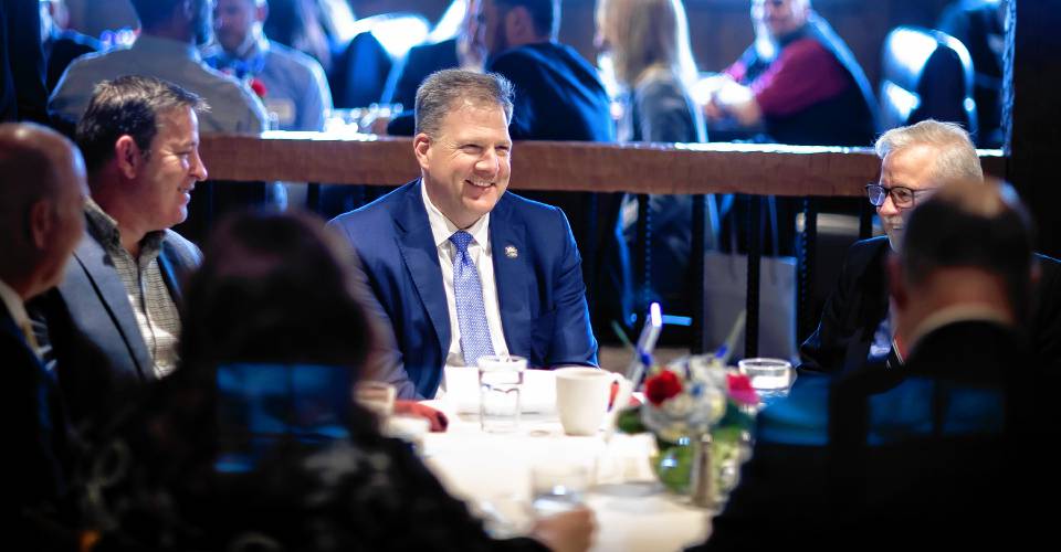 New Hampshire Governor Chris Sununu speaks with Chamber President Tim Sink and others before his last of Concord Chamber of Commerce annual State of the State luncheon at the Red Blazer on Tuesday, March 25, 2024.