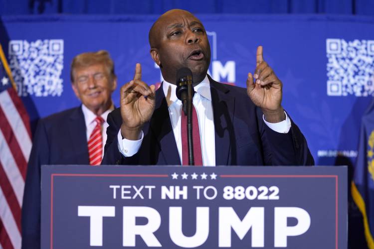 FILE - Republican presidential candidate former President Donald Trump, left, listens as Sen. Tim Scott, R-S.C., speaks at a campaign event in Concord, N.H., Jan. 19, 2024. Black voters support the reelection of President Joe Biden at a surprisingly low level, according to recent AP polling. For Republican strategists and former President Donald Trump, that's an opportunity to make inroads into the Democratic Party's most loyal voting bloc. Both parties are fine-tuning efforts to...