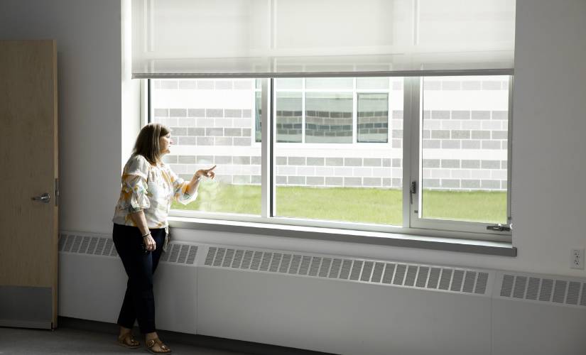 Allenstown principal Shannon Kruger looks out a new classroom window of the new Allenstown Community School  on Thursday morning, April 18, 2024. A group of students came to the school to get a greeting and a tour of the new facility.