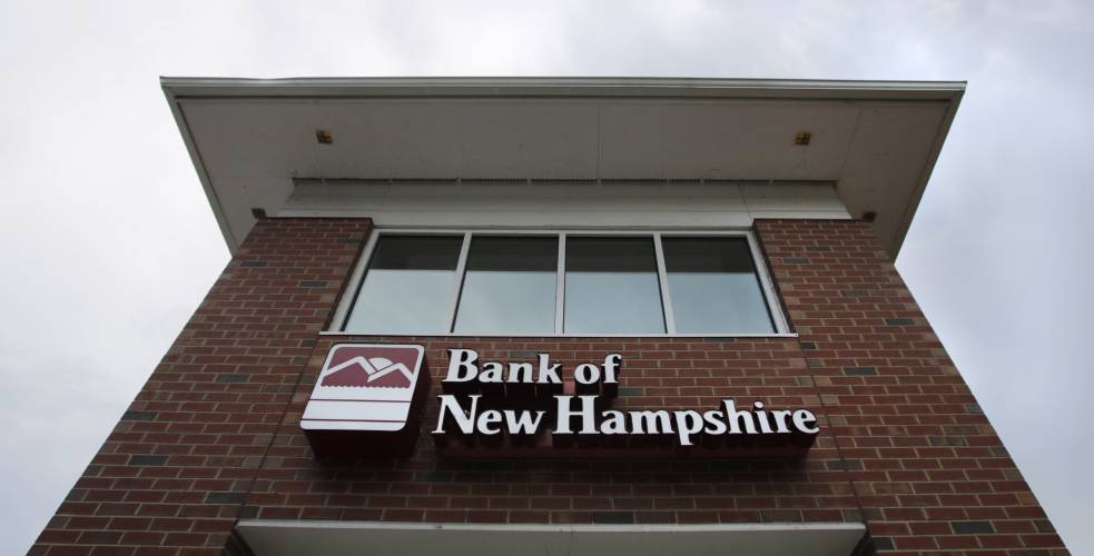 Clouds pass over the Bank of New Hampshire branch in Manchester, N.H., Monday, Aug. 19, 2019. 