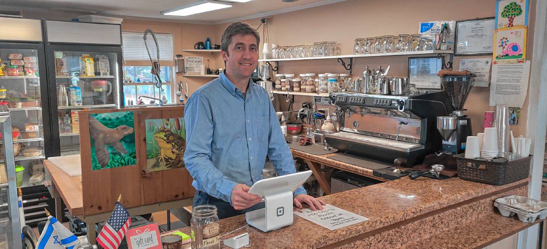Parker and Sons Coffee Roasting owner Mason Parker stands behind the counter at his Peterborough cafe.