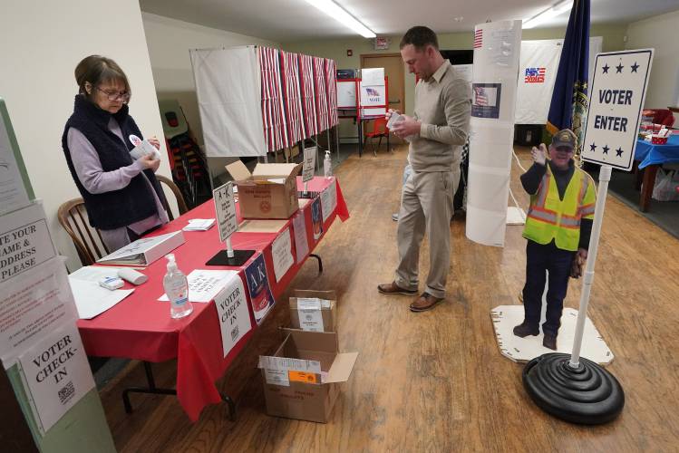 Election worker Barbara Wheelock, left, and town moderator Keith Young count ballots before the polls open for the presidential primary election, Tuesday, Jan. 23, 2024, in the Groveton village of Northumberland, N.H. 