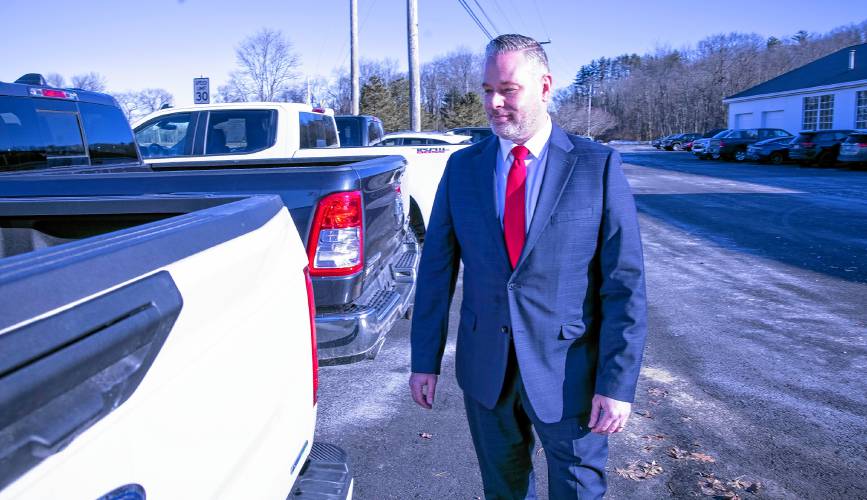 Shawn Hanlon, president of the New Hampshire and Vermont operations for Nucar, looks over the truck inventory at the new Nucar dealership on Manchester Street on Thursday, February 28.