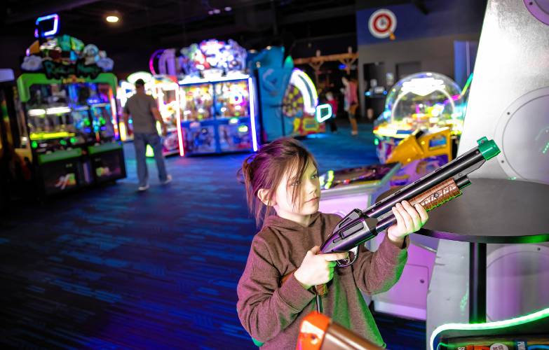 Audrey Lunn, 7, plays at the Smitty’s Cinema arcade area in Tilton on the eve of her birthday with her parents on Wednesday, April 25, 2024. The arcade couples with the movie theatre on the other side gives people a greater entertainment option.