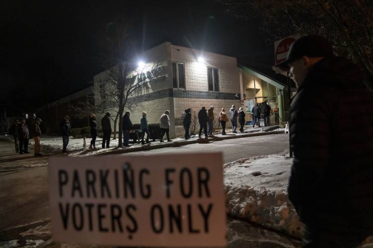 Voters enter a youth center to cast their ballots as the polls open for the New Hampshire Republican presidential primary in Manchester, N.H., Tuesday, Jan. 23, 2024. (AP Photo/David Goldman)
