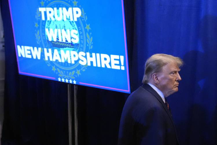 Republican presidential candidate former President Donald Trump walks backstage after speaking at a primary election night party in Nashua, N.H., Tuesday, Jan. 23, 2024. (AP Photo/Matt Rourke) 