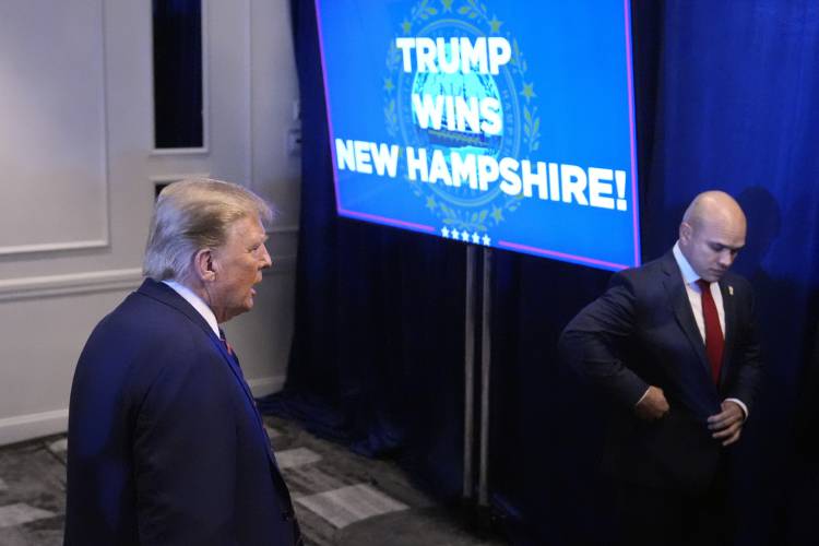 Republican presidential candidate former President Donald Trump walks backstage after speaking at a primary election night party in Nashua, N.H., Tuesday, Jan. 23, 2024. At left is valet Walt Nauta. (AP Photo/Matt Rourke) 