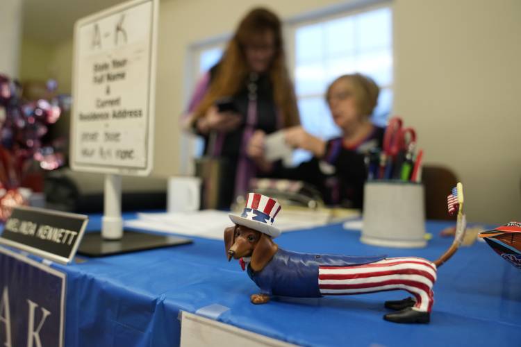 A patriotic dachshund figurine stands on Town Clerk Melinda Kennett's desk at a polling place for the presidential primary election, Tuesday, Jan. 23, 2024, in the Groveton village of Northumberland, N.H. 