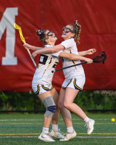Bow's Kendall Murray (left) and Kate McGovern (right) embrace after McGovern assisted on Murray’s goal to open the NHIAA Division III girls' lacrosse championship on June 6, 2023 at Bank of NH Stadium in Laconia. Murray (two goals) and McGovern (four goals, two assists) helped lead the Falcons to a 20-6 victory over St. Thomas. 