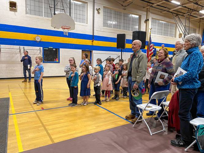 Students from the Kearsarge Regional Elementary School began the New London town meeting on Wednesday night by leading the crowd in the Pledge of Allegiance and the National Anthem.