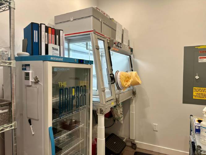 The hood stands next to a refrigerator, where some of the vitamin vials are stored. Scearbo concocts all IV bags in the hood to prevent contamination of the vitamins.