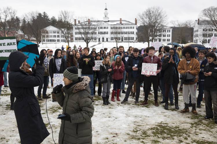 Ankita Sarkar, center, an international graduate student from India studying computer science, leads the crowd in a series of chants during a Graduate Organized Laborers of Dartmouth walkout on the green in Hanover on Wednesday.