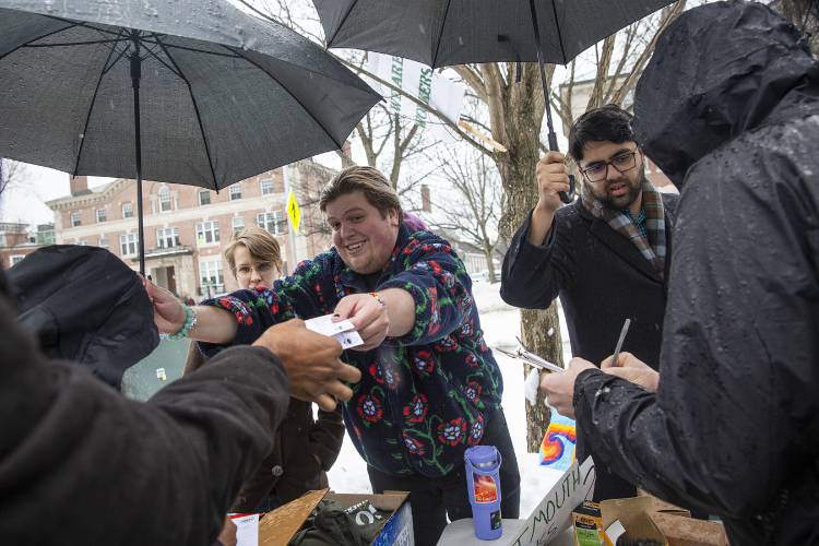 Kai Herron, left, and Muhammad Khan, both graduate students in the Department of Physics and Astronomy, hand out strike pledge cards on Wednesday.