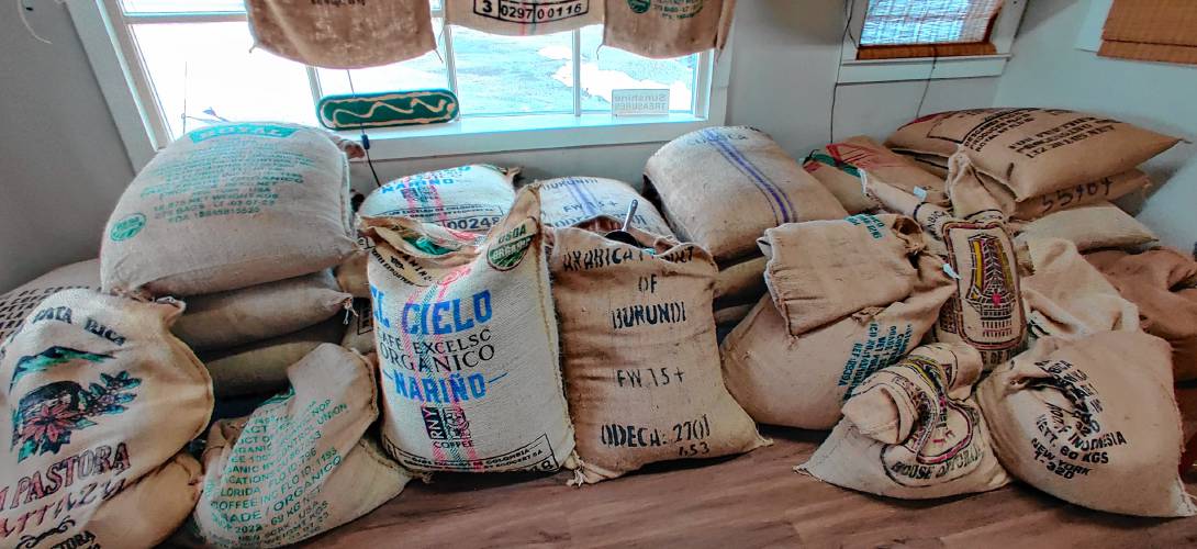 About half-a-year’s worth of raw coffee beans sit in the backroom of Parker and Sons, waiting to be roasted.