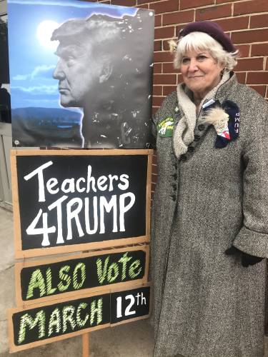 Kathy Holmes supports Donald Trump outside the polls in Chichester.