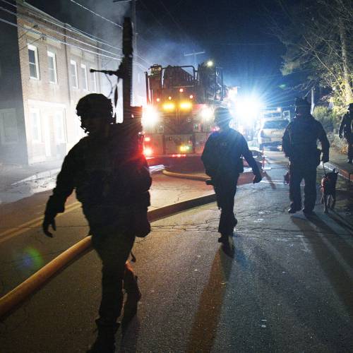New Hampshire State Police SWAT teams move toward an incident near Central and West Bow streets after a report of a barricaded suspect following an armed disturbance on Sunday night, November 19, 2023.