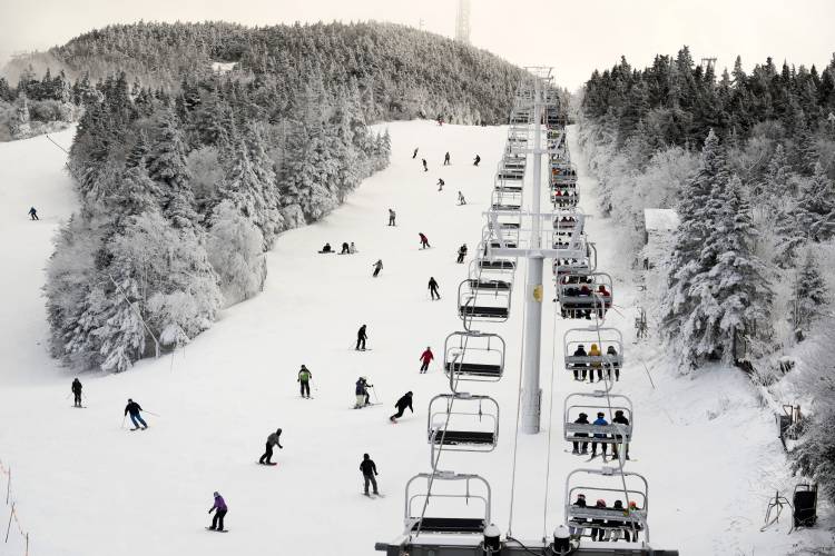 FILE - Thanksgiving holiday skiers descend near the North Ridge Quad chairlift, Nov. 24, 2023, at Killington Ski Resort in Killington, Vt. A new study says U.S. ski areas lost about 5 billion from 2000 to 2019 as a result of human-caused climate change. (AP Photo/Robert F. Bukaty, File)