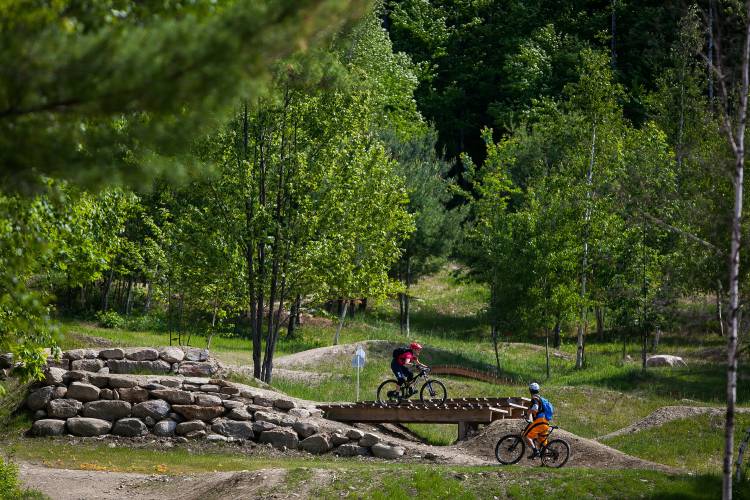 Visitors ride the trails of Central Park at Highland Mountain Bike Park in Northfield on Saturday, June 6, 2015.