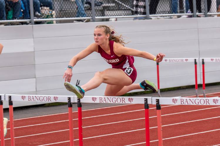 Concord's Morgan Doherty clears a hurdle in the 100-meter hurdle prelims at the New England Interscholastic Outdoor Track and Field Championship at Cameron Stadium in Bangor, Maine, on Saturday, June 10, 2023. Doherty qualified for the final, where she finished seventh.