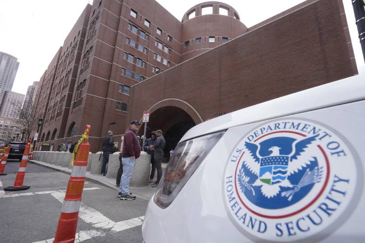FILE - A Homeland Security vehicle, right, is parked outside the Moakley Federal Courthouse, April 19, 2023, in Boston. A Boston man pleaded guilty Thursday, Jan. 25, 2024, to charges of offering to pay a contract killer 8,000 to kill his estranged wife and her boyfriend, though he was actually dealing with an undercover federal agent. (AP Photo/Steven Senne, File)