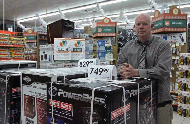 Jeff Ginn, manager of Aubuchon Hardware on South Main Street in Concord, leans on a stack of portable generators in the store on Saturday, Nov. 29, 2014. Ginn had picked up the inventory of generators from the company's Lee location on Friday but had not sold any once they were in stock. 