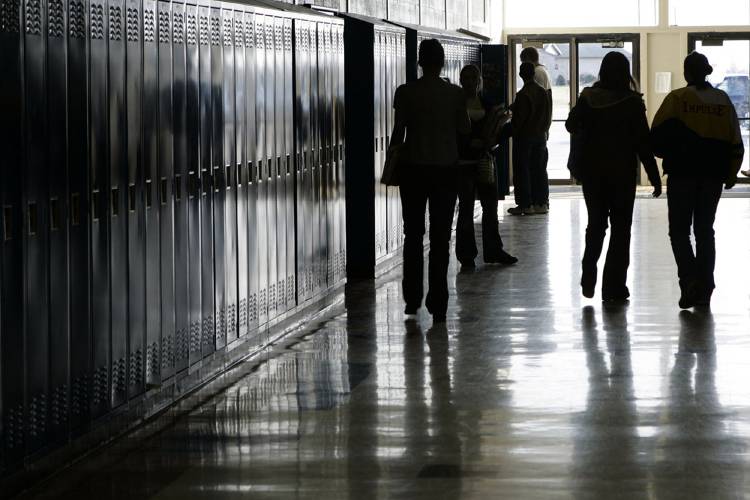 Students walk down a hallway at a high school in Iowa on Tuesday, Dec. 19, 2006. 