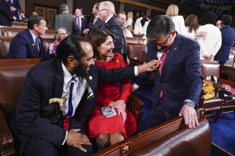 Rep. Al Green, D-Texas, left, touches the tie of Speaker of the House Mike Johnson, R-La., right, as Cathy McMorris Rodgers, R-Wash., looks on before President Joe Biden delivers the State of the Union address to a joint session of Congress at the Capitol, Thursday, March 7, 2024, in Washington. (Shawn Thew/Pool via AP)