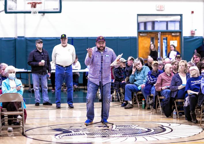 Resident Matt Petersons asks a question about the Memorial Park drainage improvements article at the Pembroke Town Meeting on Saturday. Pembroke voters approved a $11.6 million budget, a 14.5% increase to the town’s tax rate.