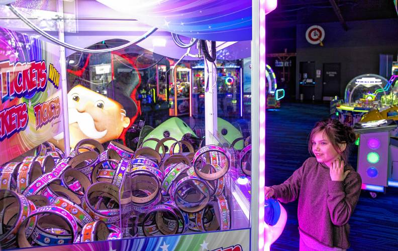 Audrey Lunn, 7, plays at the Smitty’s Arcade in Tilton on the eve of her birthday with her parents on Wednesday, April 25, 2024. The arcade couples with the movie theatre on the other side gives people a greater entertainment option.