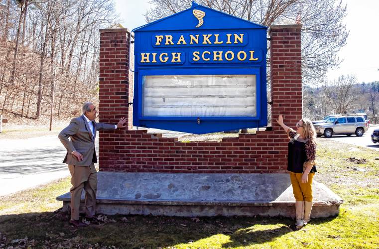 Former Franklin assistant principal Bill Athanas and teacher Jule Finley outside the current Franklin High School sign on Monday, April 9, 2024. Athanas saw the sign, worn and tired, outside Franklin High School and decided to update it.