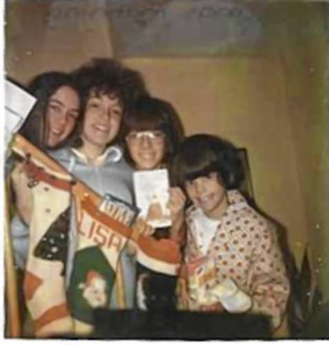 The siblings, (from left), Kira, Lisa, Rick and Darren in a 1975 Polaroid on the stairway on Christmas morning.