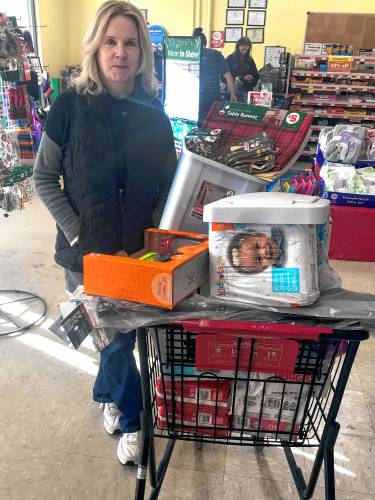 Margie Ackerson of Concord waits in the checkout  at the Family Dollar store on Fisherville Road on Thursday.