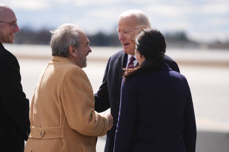 President Joe Biden is greeted as he arrives at Manchester-Boston Regional Airport for an event on lowering prices for American families, Monday, March 11, 2024, in Manchester, N.H. (AP Photo/Evan Vucci)