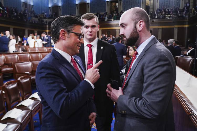 House Speaker Mike Johnson, R-La., left, speaks with a member of his staff before President Joe Biden delivers the State of the Union address to a joint session of Congress at the Capitol, Thursday, March 7, 2024, in Washington. (Shawn Thew/Pool via AP)