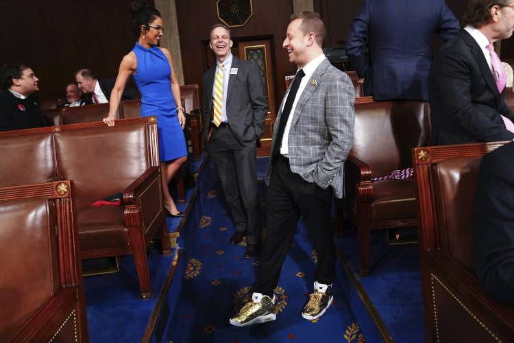 Rep. Jared Moskowitz, D-Fla., from right, stands in sneakers as Rep. Scott Perry, R-Pa. and Rep. Lauren Boebert, R-Colo., look on before President Joe Biden delivers the State of the Union address to a joint session of Congress at the Capitol, Thursday, March 7, 2024, in Washington. (Shawn Thew/Pool via AP)