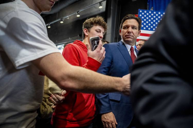 FILE - Republican presidential candidate Florida Gov. Ron DeSantis, right, greets members of the audience at a rally in Grimes, Iowa, Jan. 7, 2024. DeSantis has suspended his Republican presidential campaign after a disappointing showing in Iowa's leadoff caucuses. He ended his White House bid Sunday, Jan. 21, after failing to meet lofty expectations that he would seriously challenge former President Donald Trump. (AP Photo/Andrew Harnik, File)