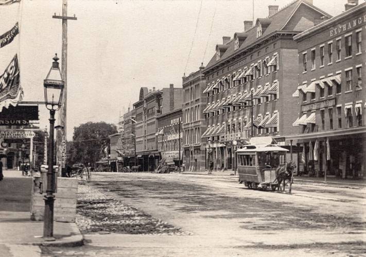 A very early view of Main Street in Concord depicting an early gas lantern. Gas lanterns were used prior to the invention of the electric light to keep our Main Street illuminated for evening shoppers.