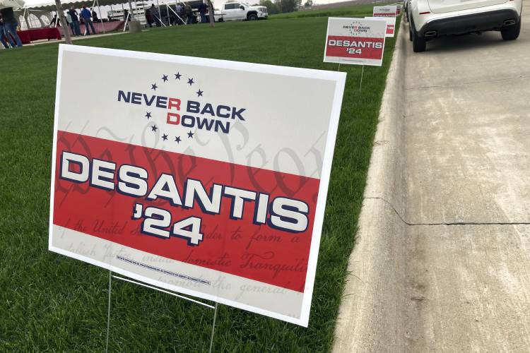 FILE - Yard signs promoting Florida Gov. Ron DeSantis in 2024, financed by the super PAC promoting DeSantis for president, line the street leading up to a Republican congressional fundraiser, May 13. 2023, in Sioux Center, Iowa. DeSantis has suspended his Republican presidential campaign after a disappointing showing in Iowa's leadoff caucuses. He ended his White House bid Sunday, Jan. 21, 2024, after failing to meet lofty expectations that he would seriously challenge former...