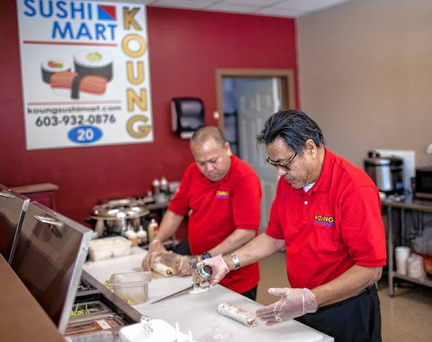 Owner Myint Soe, right, of the new Koung Sushi Mart makes a roll with his cousin, Ray Soe, at the Loudon Road location in Concord. Soe opened on December 1 and has a restaurant in Laconia as well.