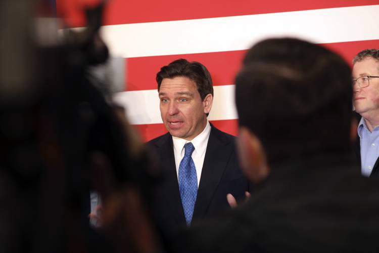 Republican presidential candidate Florida Gov. Ron DeSantis takes questions from reporters after a rally on Tuesday, Jan. 16, 2024, in Greenville, S.C. (AP Photo/Jeffrey Collins)