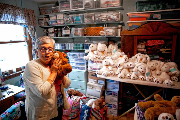 Nancy Peperissa in her sewing room in her Penacook home where she puts the finishing touches on making skull caps for chemotherapy patients and filling teddy bears with rice to comfort Alzheimer patients.