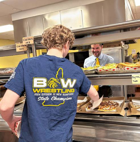 Incoming Bow High School principal Matt Fisk helps staff serve lunch to  students last Wednesday, April 17.