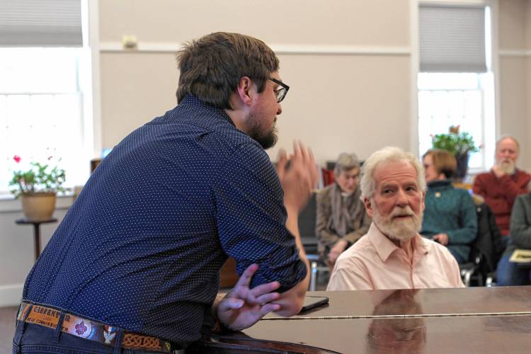 Kearsarge Chorale Artistic Director Alex Ager discusses music with collaborative pianist David Almond at a recent rehearsal.